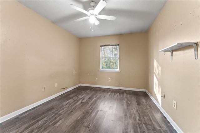 spare room featuring ceiling fan and dark wood-type flooring