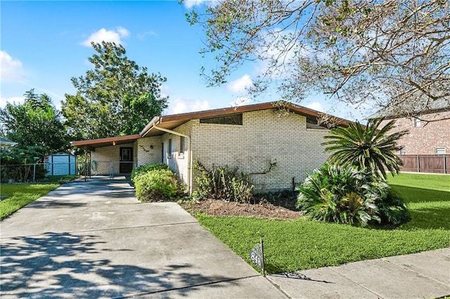 view of front of home with a carport and a yard