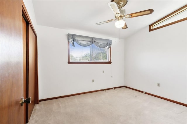 basement with a wall mounted AC and ceiling fan