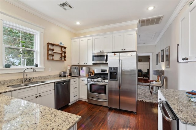 kitchen featuring white cabinetry, sink, stainless steel appliances, and light stone counters