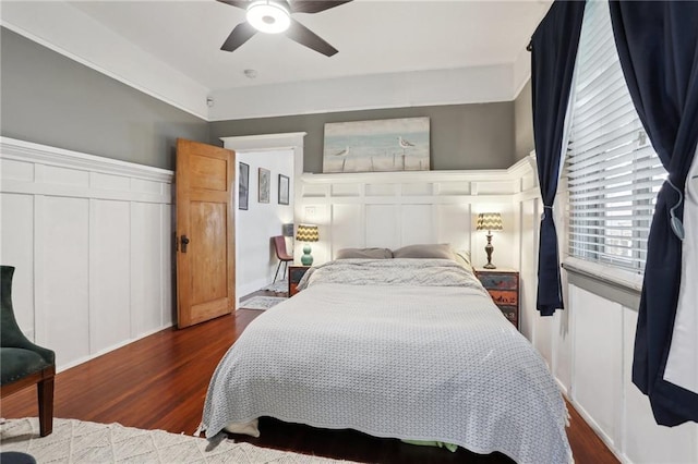 bedroom with ceiling fan and dark hardwood / wood-style flooring