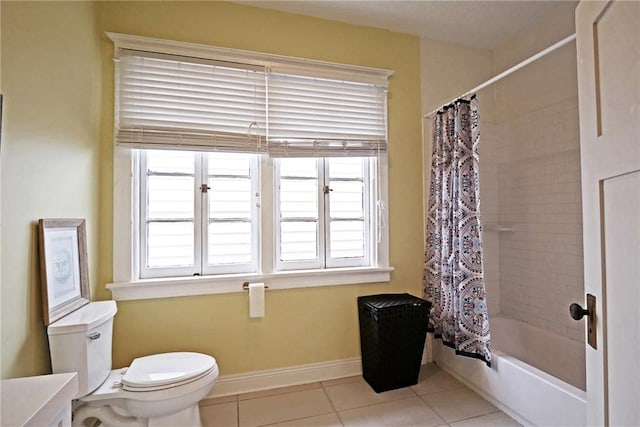 bathroom featuring shower / bath combo with shower curtain, toilet, and tile patterned flooring