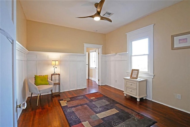 living area featuring dark hardwood / wood-style floors and ceiling fan