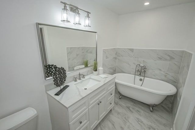 bathroom with a bathtub, vanity, and toilet