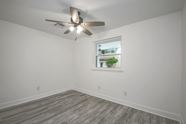 empty room with dark hardwood / wood-style flooring and ceiling fan