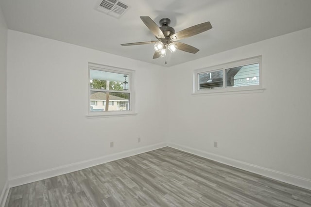 empty room featuring hardwood / wood-style floors and ceiling fan