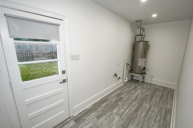 washroom featuring hardwood / wood-style floors and gas water heater