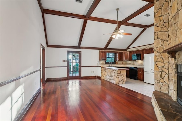 kitchen featuring dark hardwood / wood-style flooring, vaulted ceiling with beams, decorative backsplash, black appliances, and ceiling fan