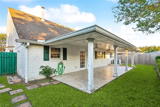 back of house with ceiling fan, a patio, and a yard