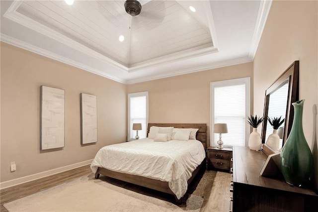 bedroom with light hardwood / wood-style flooring, crown molding, wood ceiling, and a raised ceiling