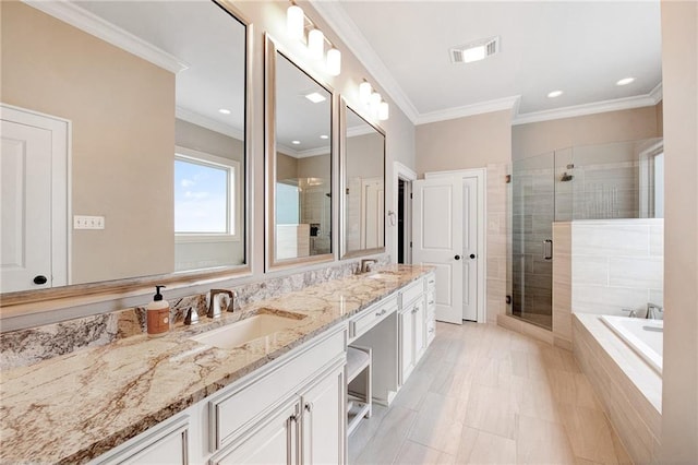 bathroom with vanity, shower with separate bathtub, and crown molding