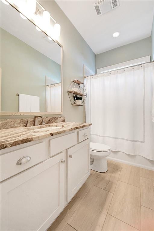 full bathroom with toilet, shower / tub combo, and vanity