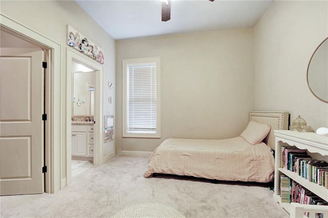 carpeted bedroom featuring ensuite bathroom and ceiling fan