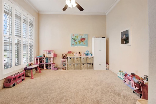 recreation room featuring crown molding, carpet flooring, and ceiling fan