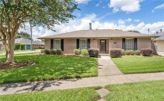 single story home featuring a front lawn and brick siding