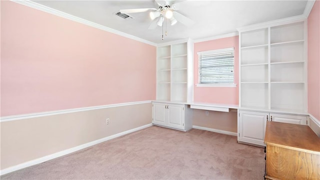 unfurnished bedroom featuring built in desk, visible vents, ornamental molding, light carpet, and baseboards