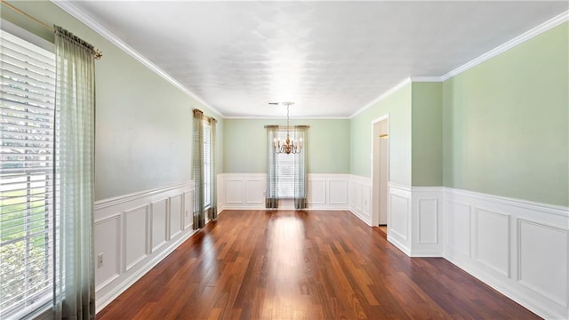 unfurnished dining area with a decorative wall, dark wood-style floors, a notable chandelier, and wainscoting