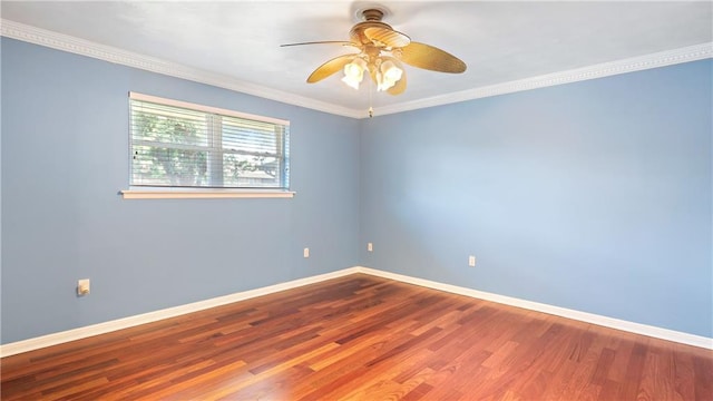 empty room featuring ceiling fan, baseboards, crown molding, and wood finished floors