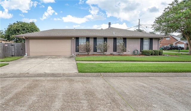 single story home featuring driveway, an attached garage, fence, a front yard, and brick siding