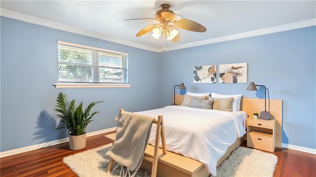 bedroom with baseboards, a ceiling fan, wood finished floors, and crown molding