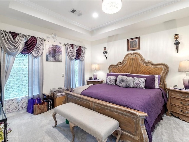 carpeted bedroom featuring a tray ceiling and ornamental molding