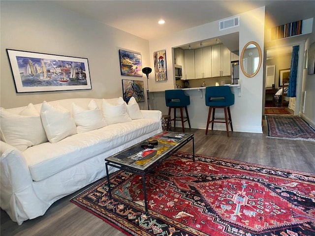 living room with dark hardwood / wood-style floors