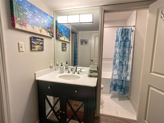 bathroom featuring tile patterned flooring, vanity, and shower / bath combination with curtain