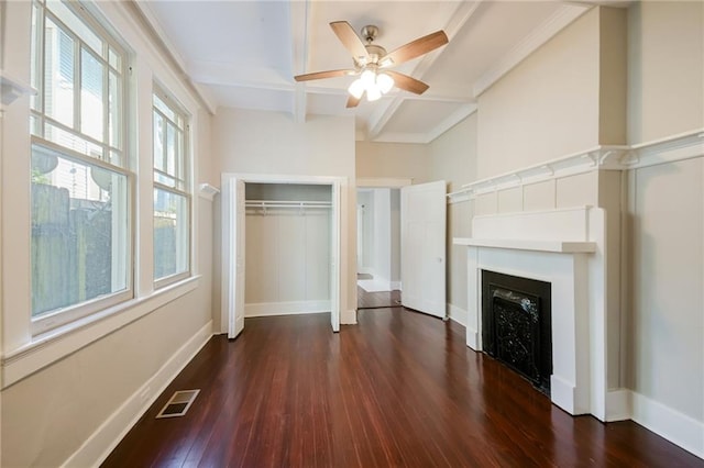 unfurnished bedroom featuring beamed ceiling, ceiling fan, and dark wood-type flooring