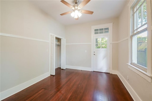 unfurnished bedroom featuring dark hardwood / wood-style floors and ceiling fan