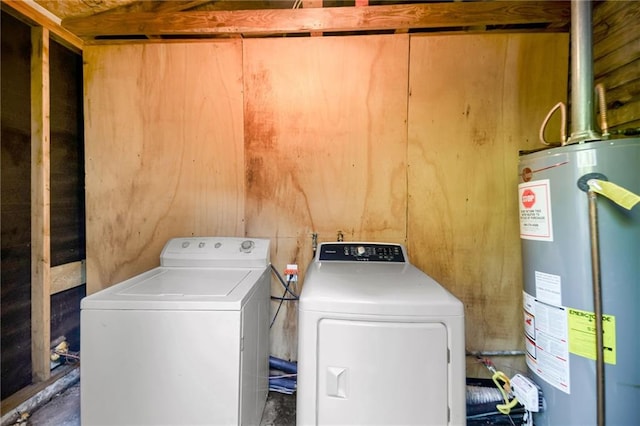 washroom with gas water heater and washer and dryer