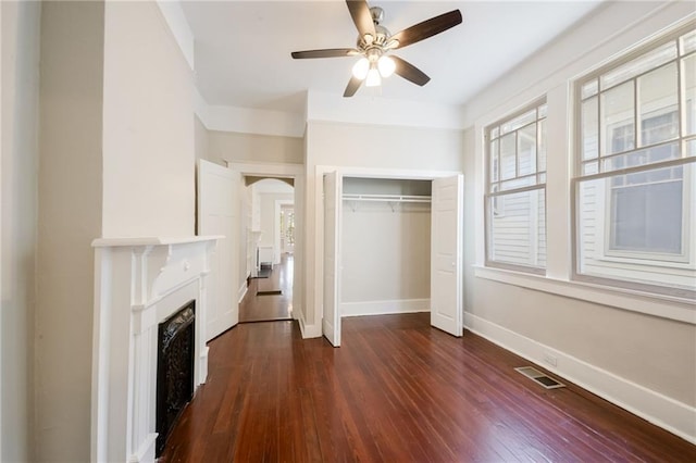 unfurnished bedroom featuring a closet, ceiling fan, and dark hardwood / wood-style floors