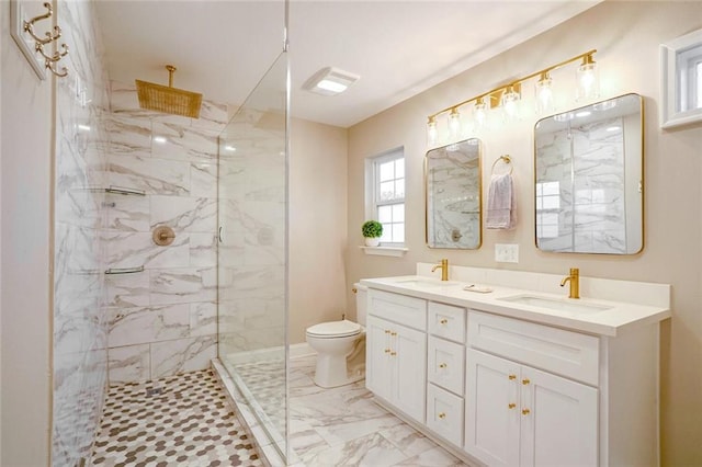 bathroom featuring vanity, toilet, and a tile shower