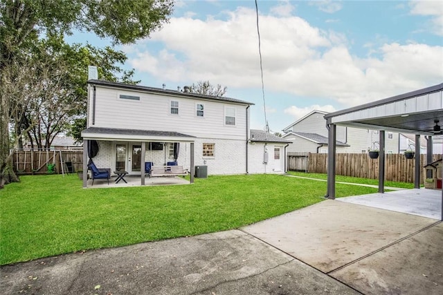 rear view of house featuring a lawn, cooling unit, a patio, and french doors