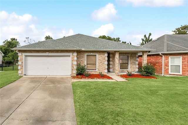 view of front of home with a garage and a front lawn