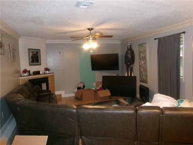 living room with a textured ceiling, ceiling fan, and crown molding