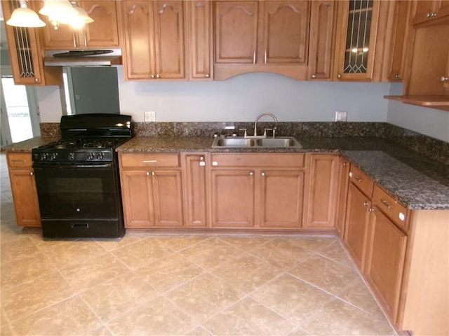 6919 Virgilian St, New Orleans, LA 70126 - kitchen featuring glass insert cabinets, brown cabinetry, under cabinet range hood, gas stove, and a sink