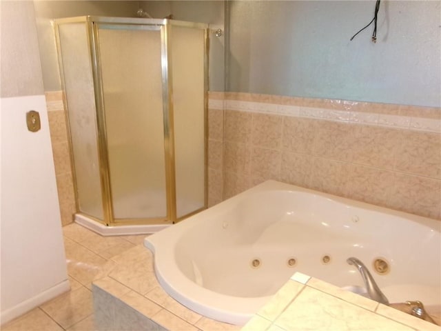 6919 Virgilian St, New Orleans, LA 70126 - bathroom with a shower stall, a jetted tub, and tile patterned flooring