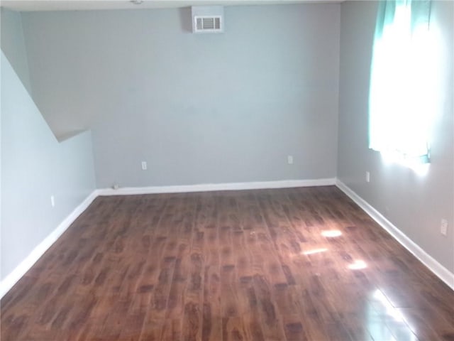 6919 Virgilian St, New Orleans, LA 70126 - unfurnished room with dark wood-type flooring, visible vents, and baseboards