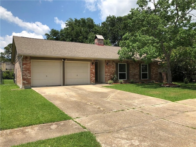 single story home with a garage and a front lawn