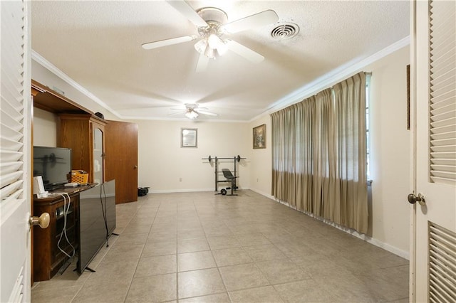 workout room with light tile patterned floors, a textured ceiling, ceiling fan, and ornamental molding