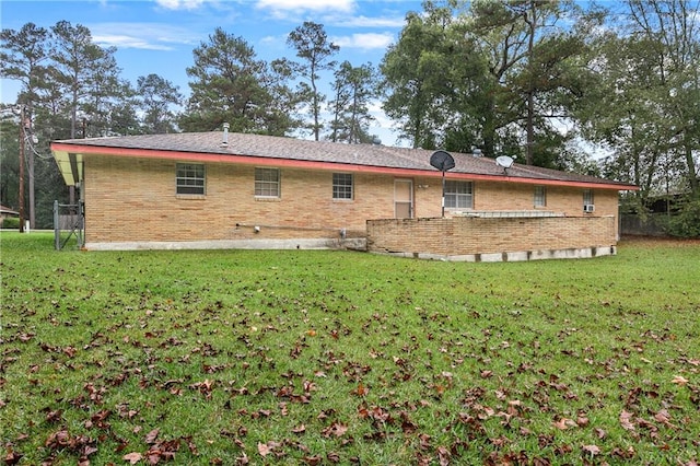 back of property featuring a lawn