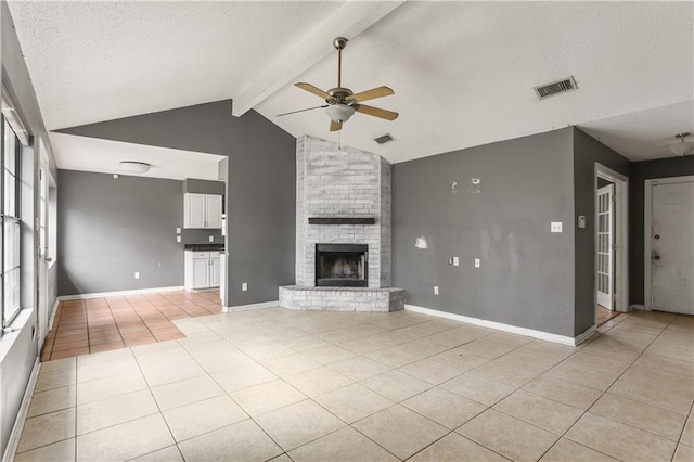 unfurnished living room featuring a fireplace, ceiling fan, plenty of natural light, and lofted ceiling with beams