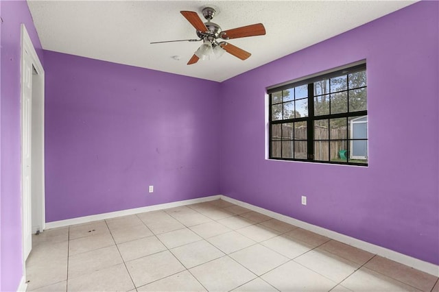 tiled spare room featuring ceiling fan and a textured ceiling