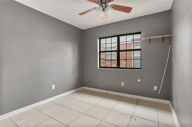 empty room featuring ceiling fan and light tile patterned floors