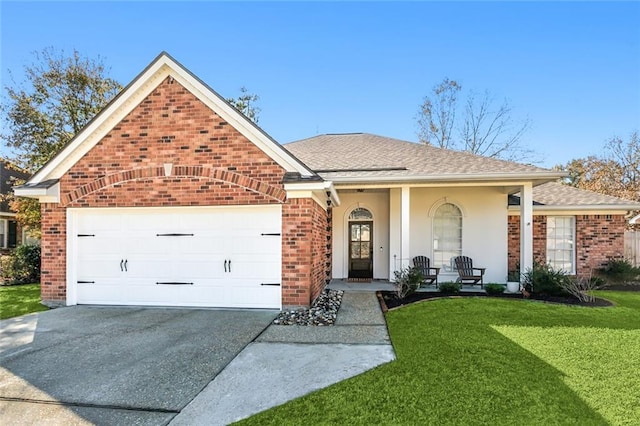 view of front of property featuring a garage, covered porch, and a front yard