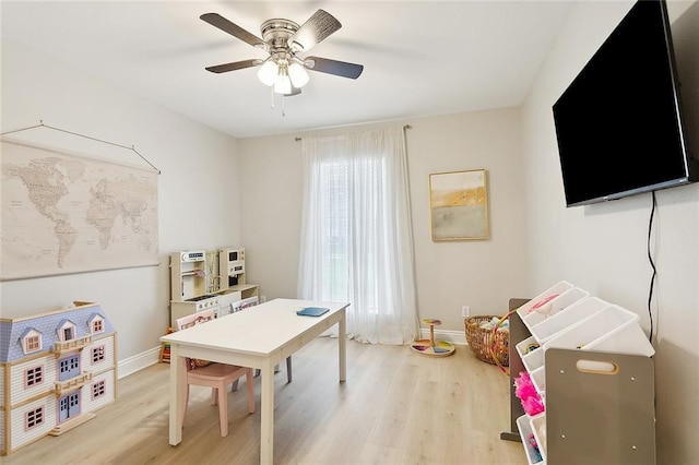 recreation room featuring light wood-type flooring, ceiling fan, and plenty of natural light