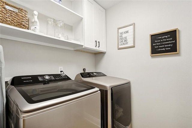 laundry room featuring cabinets and separate washer and dryer