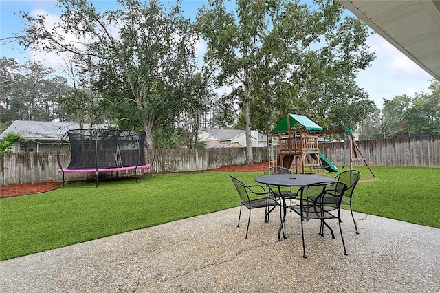 view of patio with a playground and a trampoline