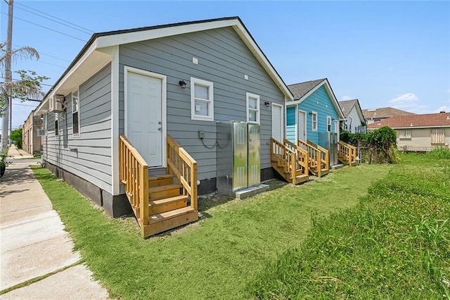 rear view of property with a lawn