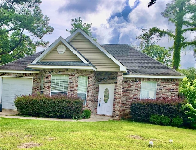 view of front of house featuring a garage and a front lawn